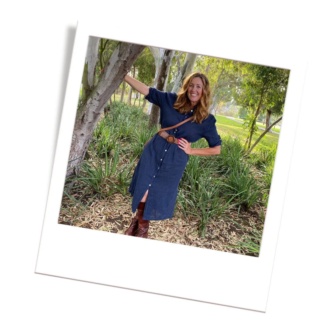 Diana outdoors in a navy dress, in a photograph with a white frame